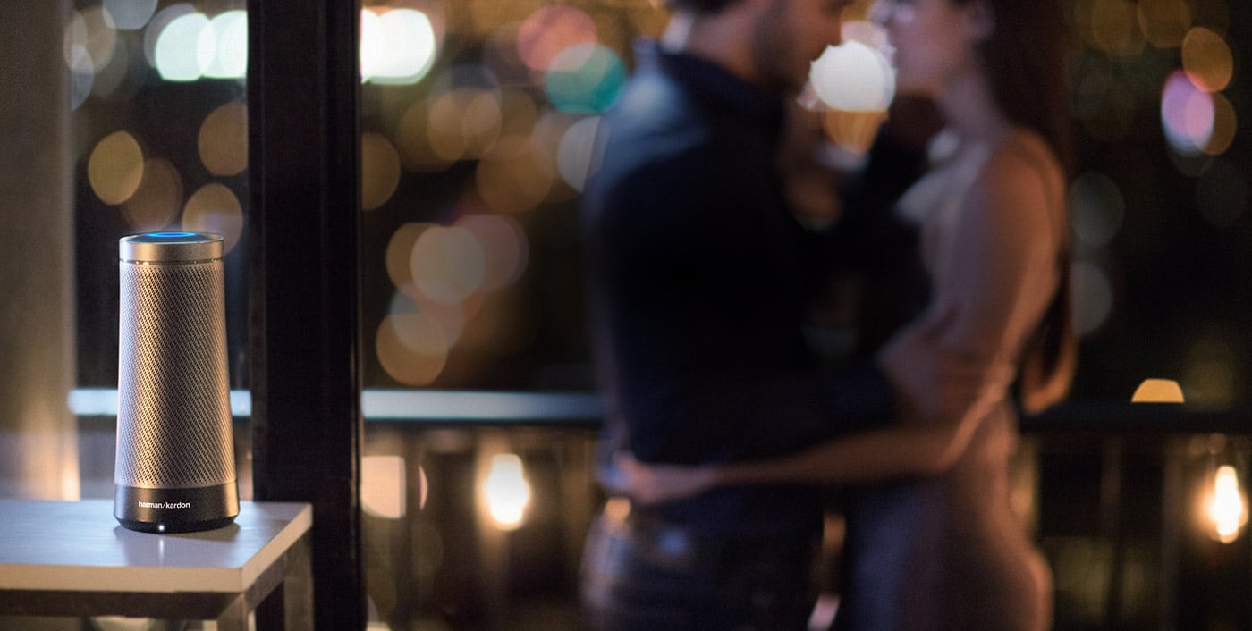 Two people slow dancing next to an Invoke speaker