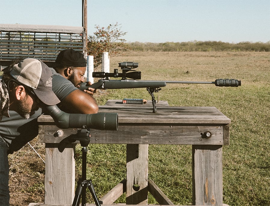 Pro footballer Fletcher Cox siting in a rifle outfitted with a supressor