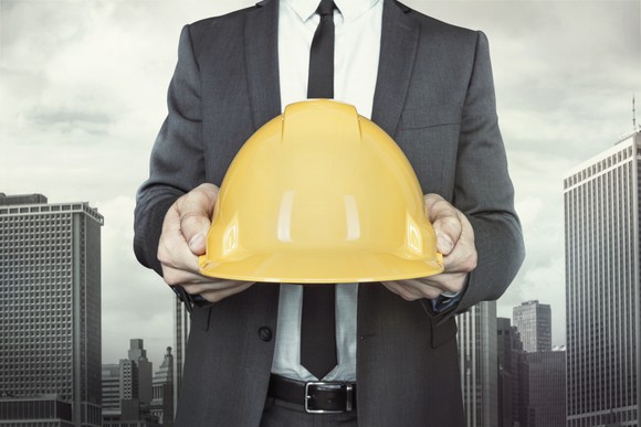 A man holding a hardhat.