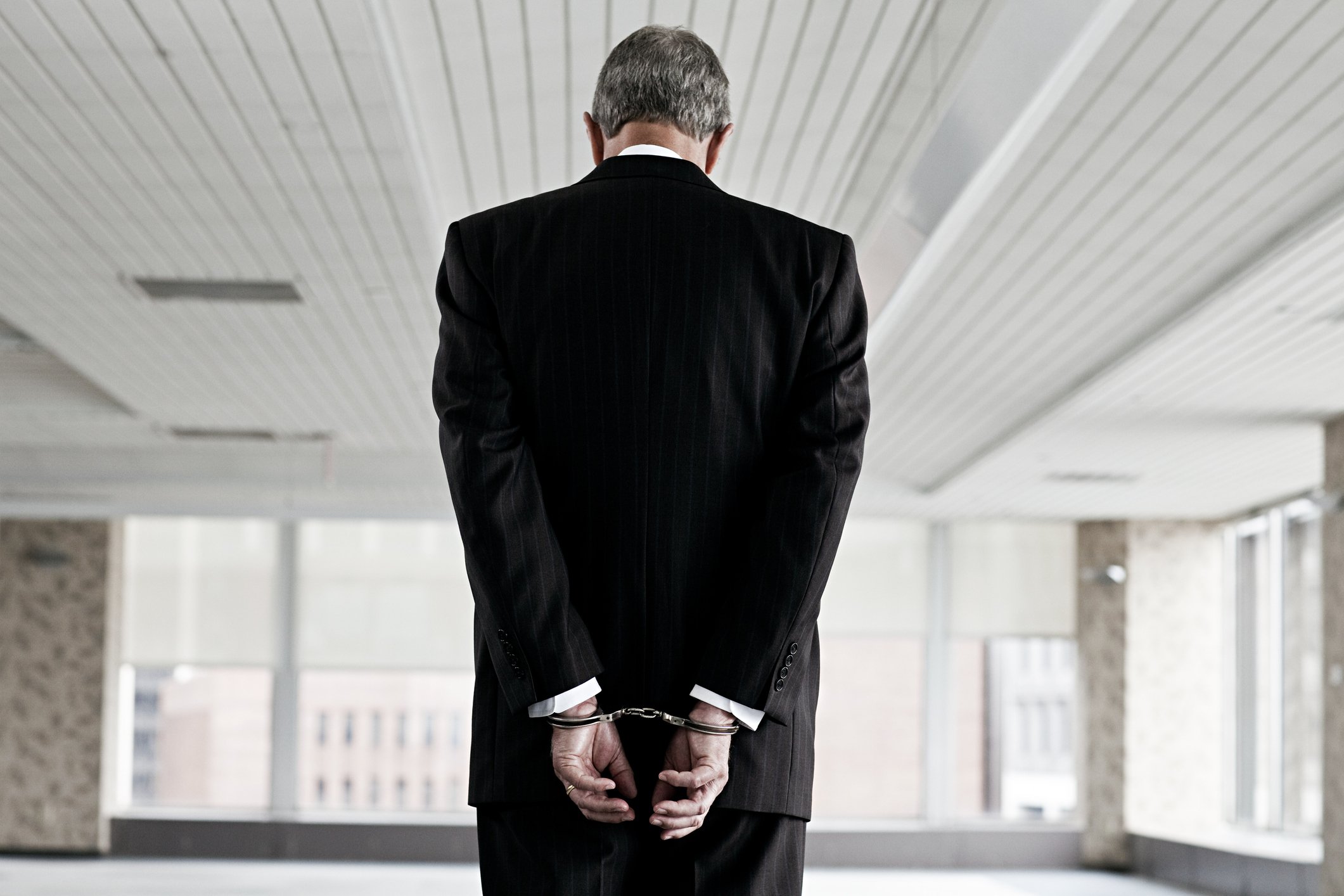 A businessman in handcuffs.