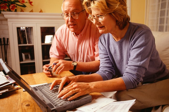 senior couple using laptop