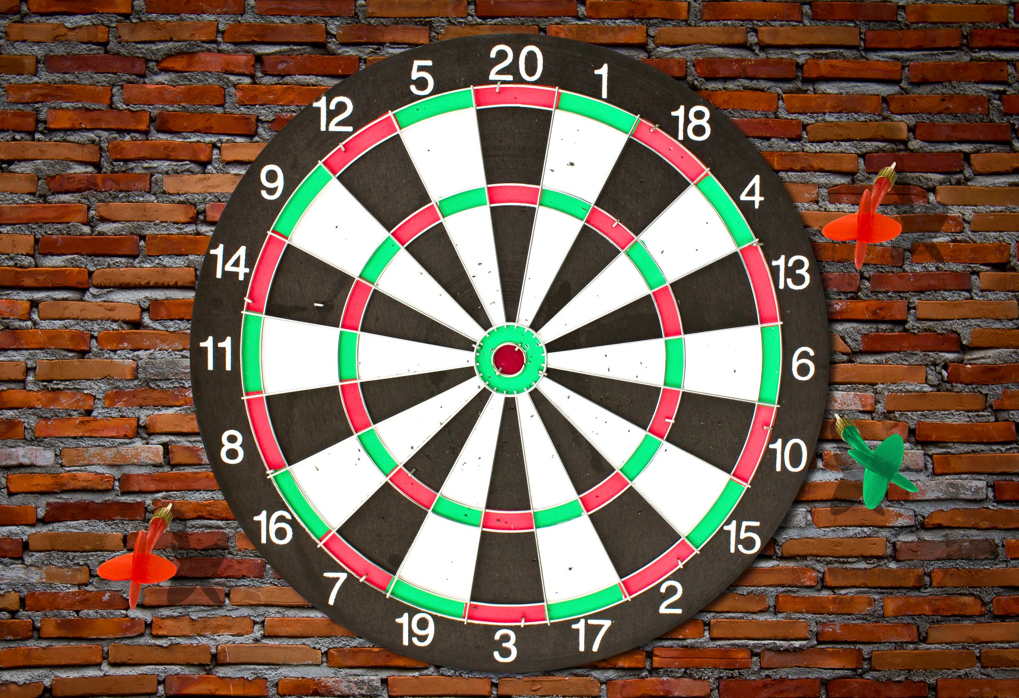 Thrown darts badly miss the dartboard. 