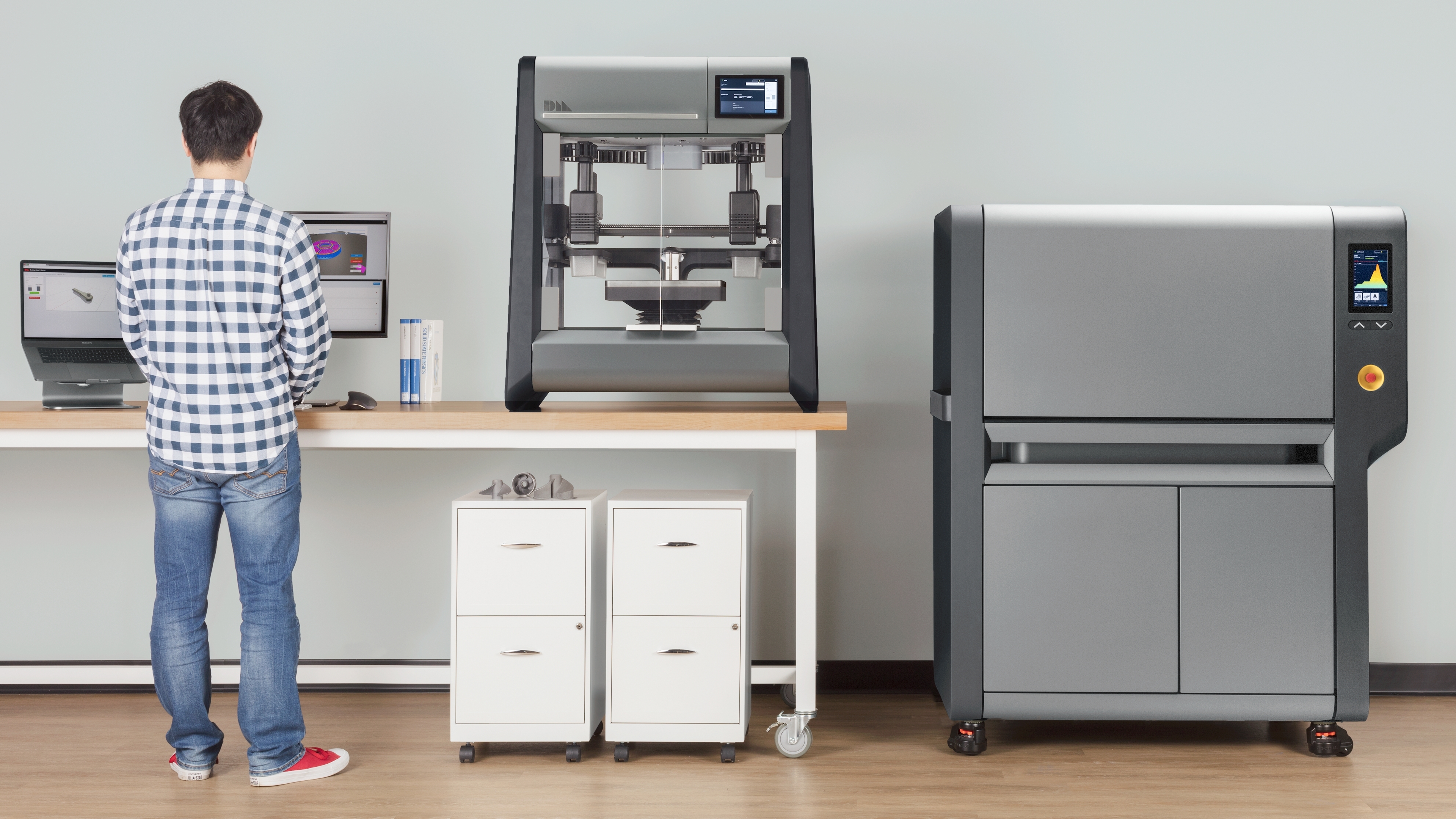 Desktop Metal's two 3D printers shown in an office.