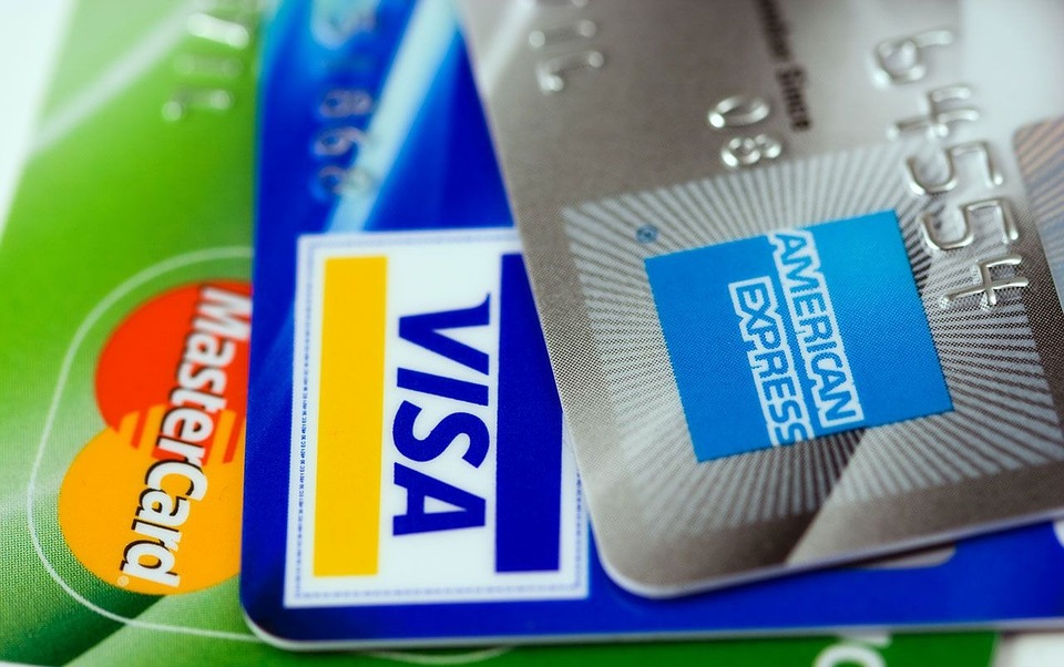 An American Express card, Visa card, and Mastercard card