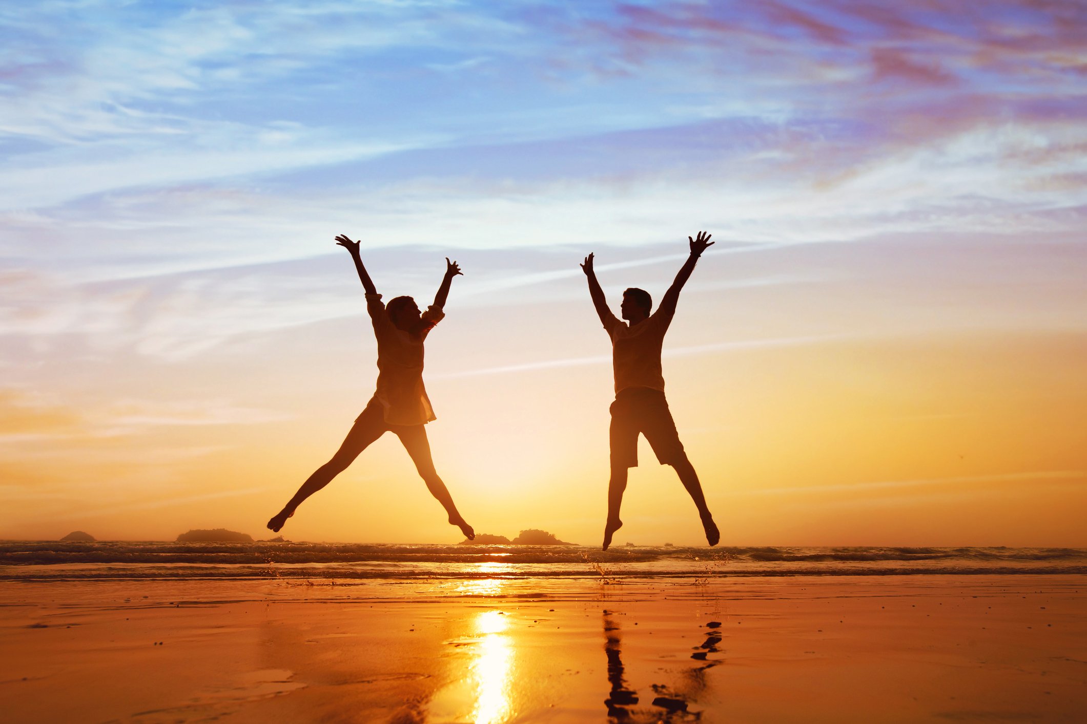 People jumping for joy on the beach