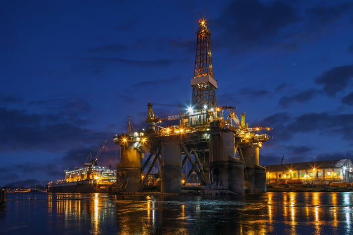 An offshore rig in dock at night