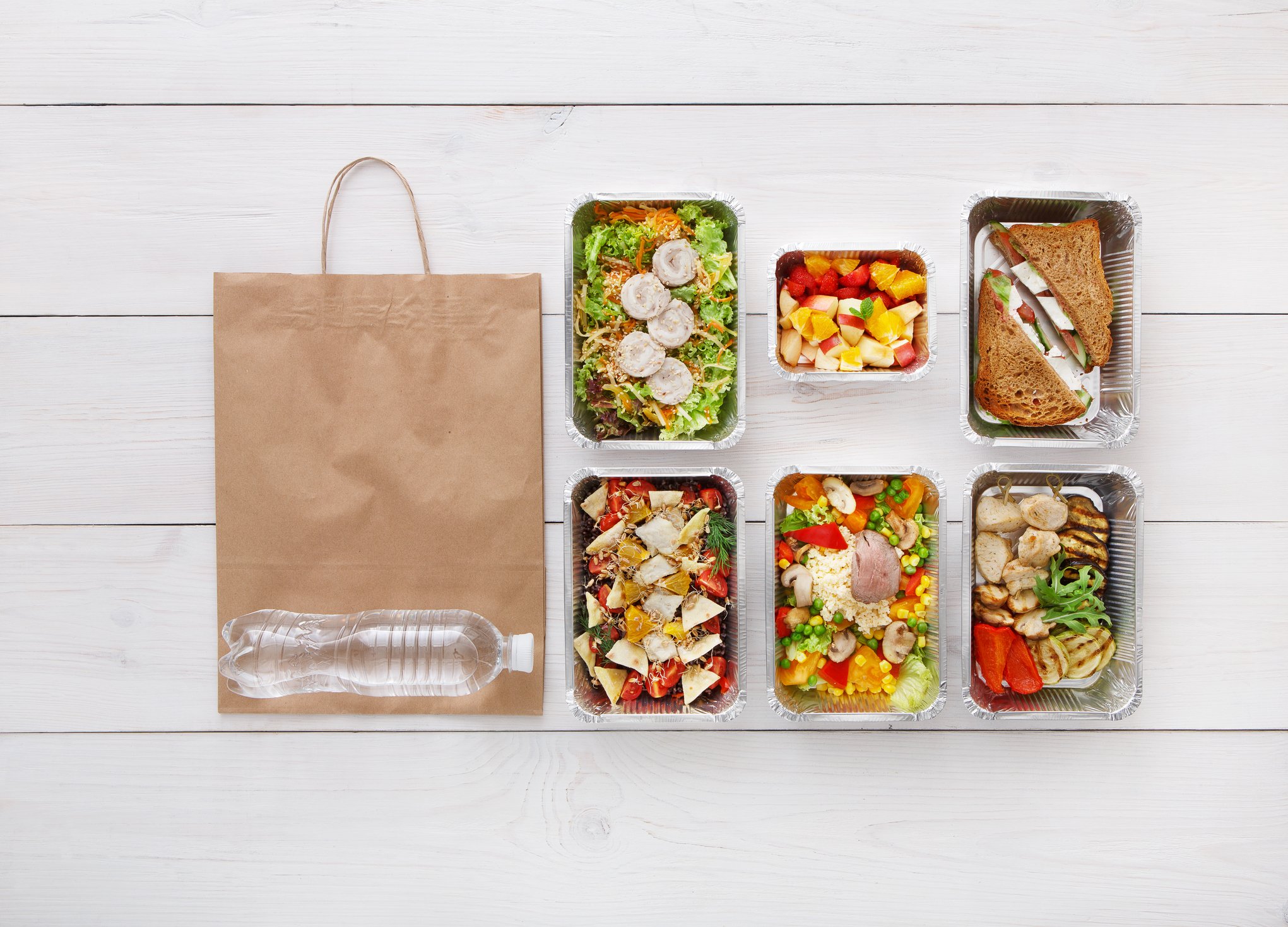 Pre-packaged meals with a bag on the floor. 