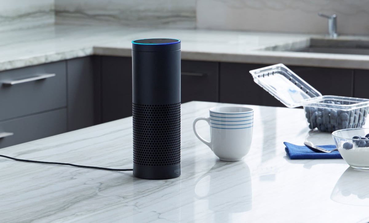 Amazon Echo sitting on kitchen countertop.