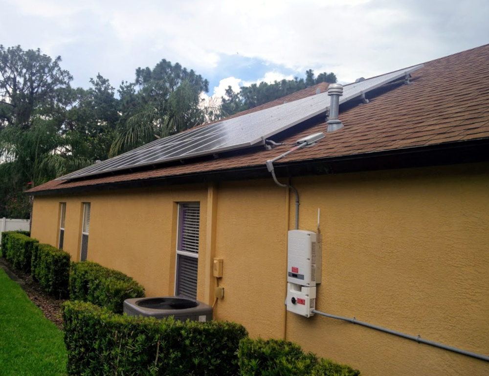 Solar panels and monitoring box with a wireless antenna, installed on a typical Floridian home.