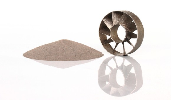 A 3D-printed metal part next to metal powder.
