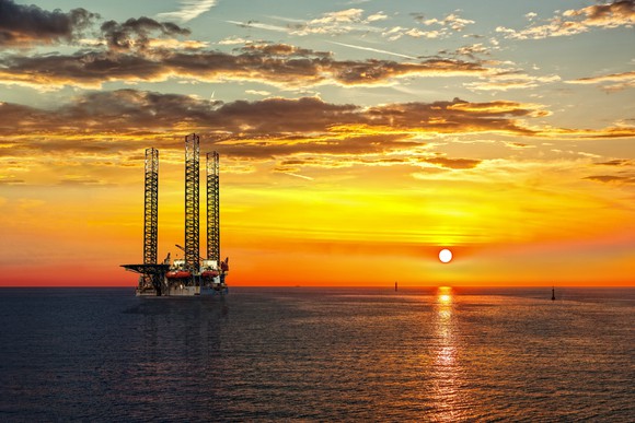 An oil drilling rig at sunset.