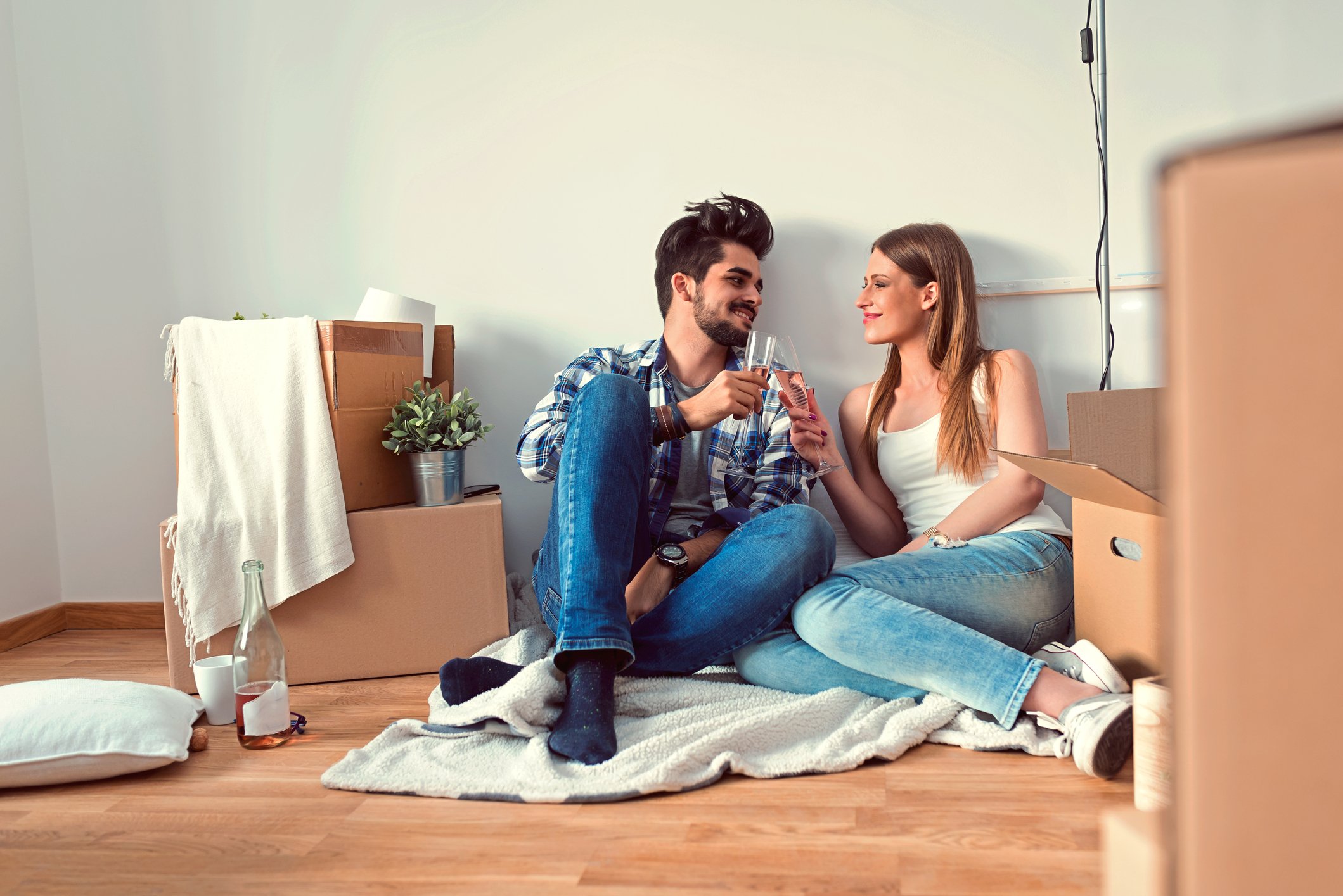 Young couple with boxes, moving into a new place