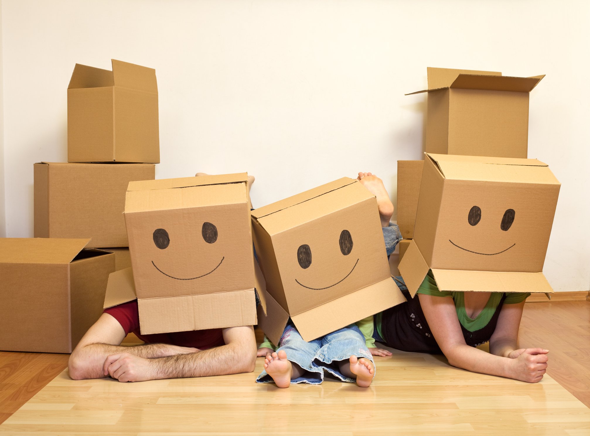 A family playing with cardboard boxes.