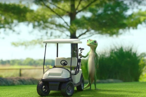 The GEICO gecko loading up a golf cart