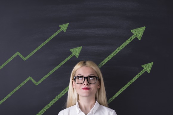 Person looking up at a series of upward sloping arrows.