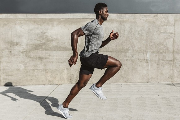 Man running down sidewalk wearing Lululemon's Metal Vent Tech running top.