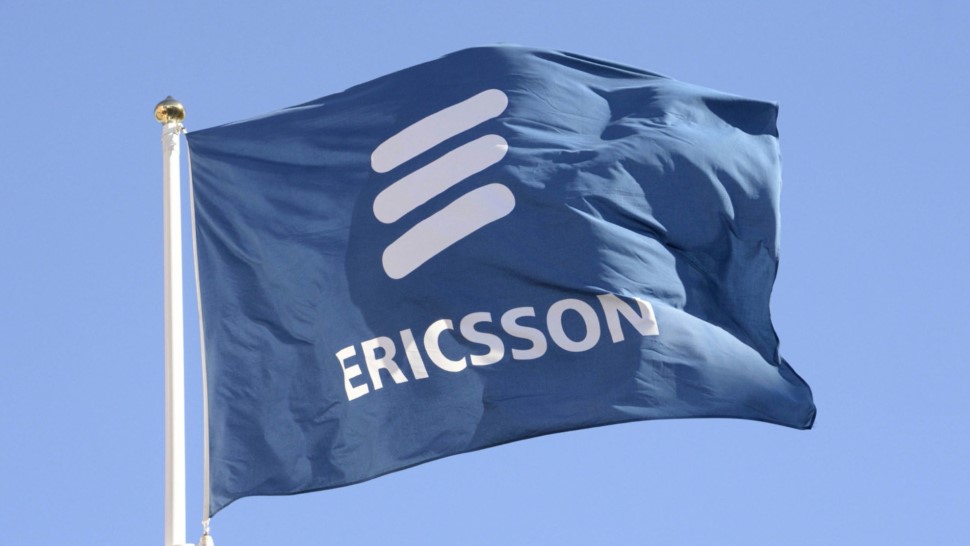 A flag flying in the wind sports the Ericsson logo.
