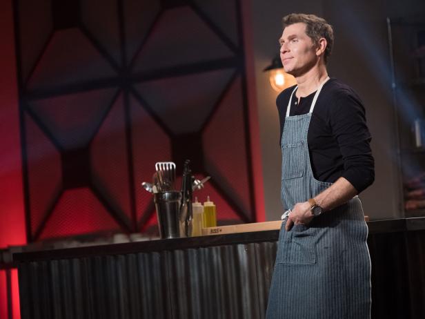 Food Network chef Bobby Flay on a set wearing an apron