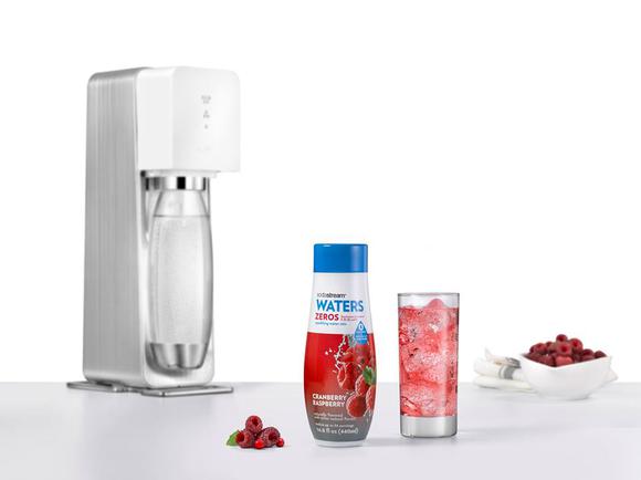 A sodastream machine with sparkling water flavoring.