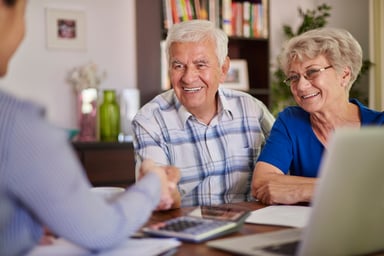 Retired couple talking with professional