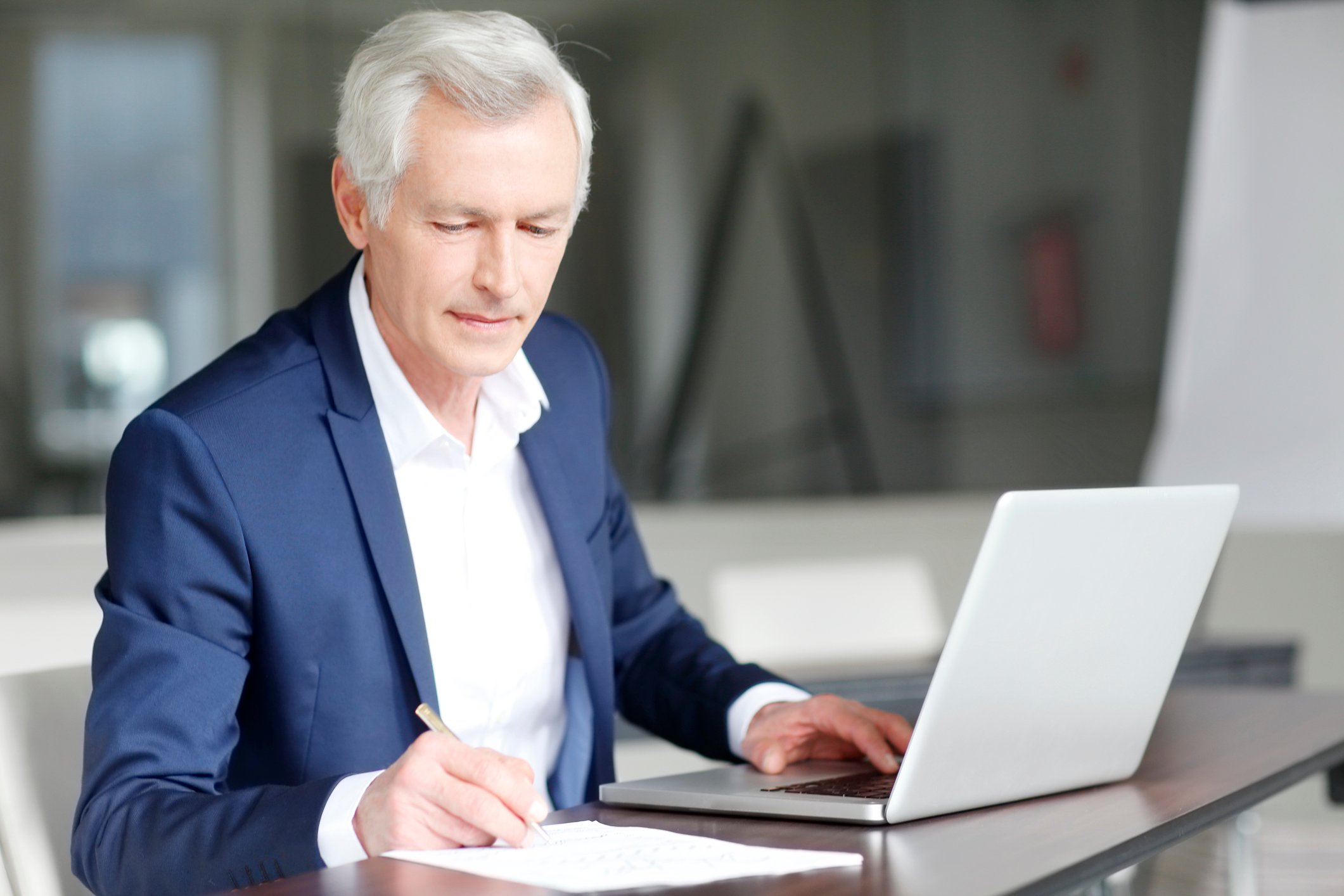 Older businessman working at a computer.