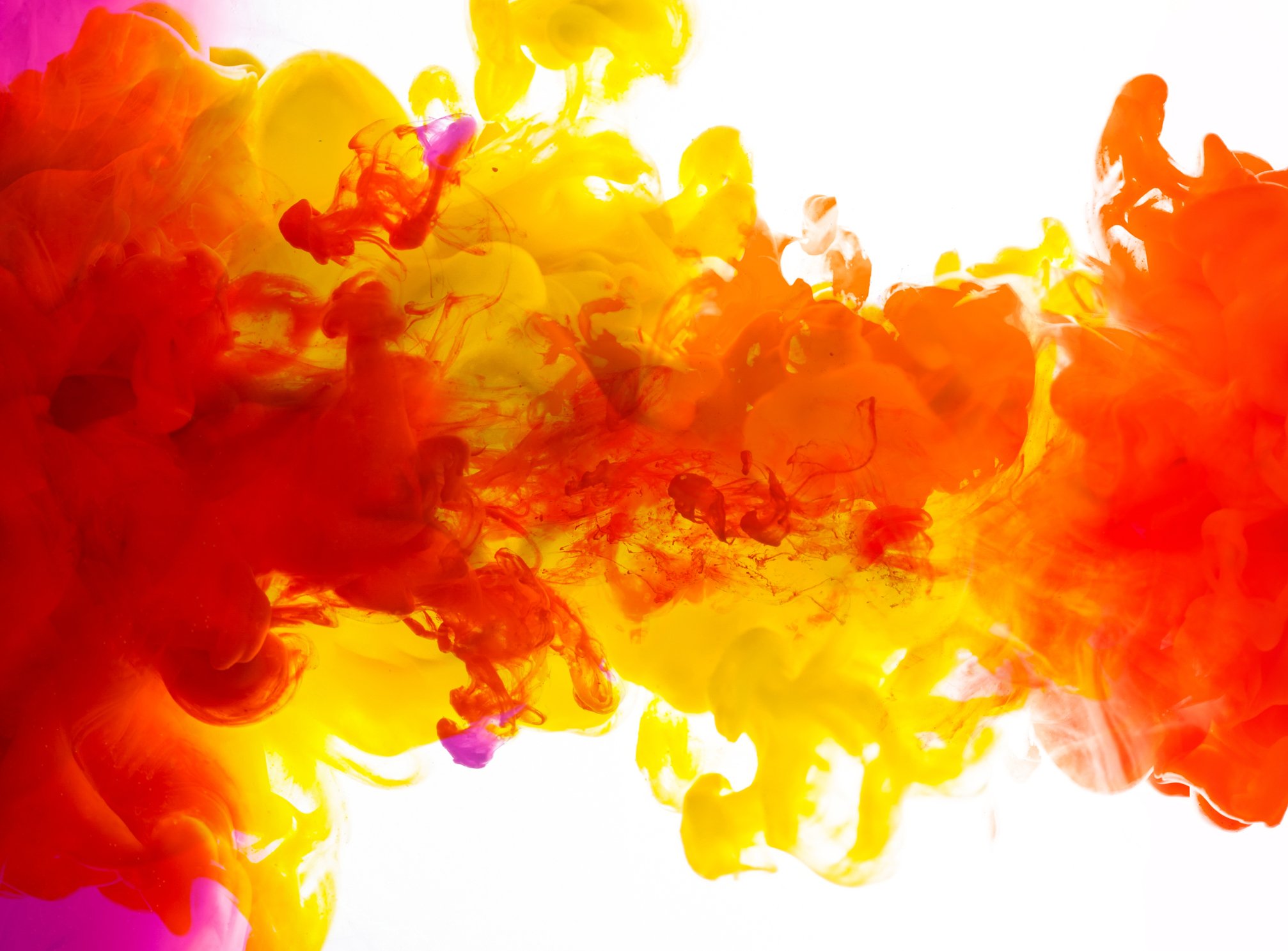 A variety of colors of ink blend together underwater.