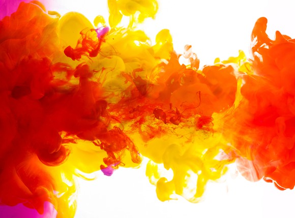 A variety of colors of ink blend together underwater.