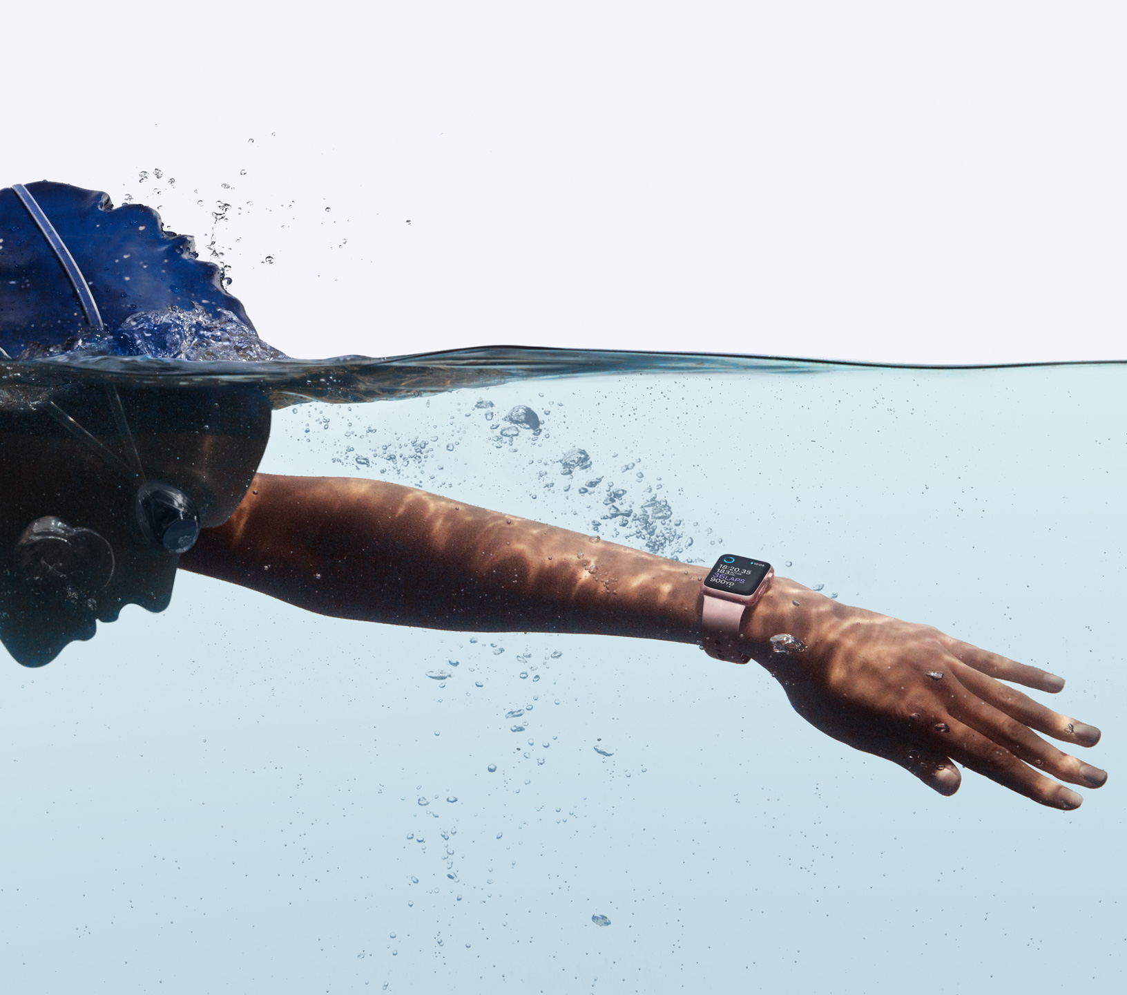 A swimmer with an Apple Watch submerged under water.