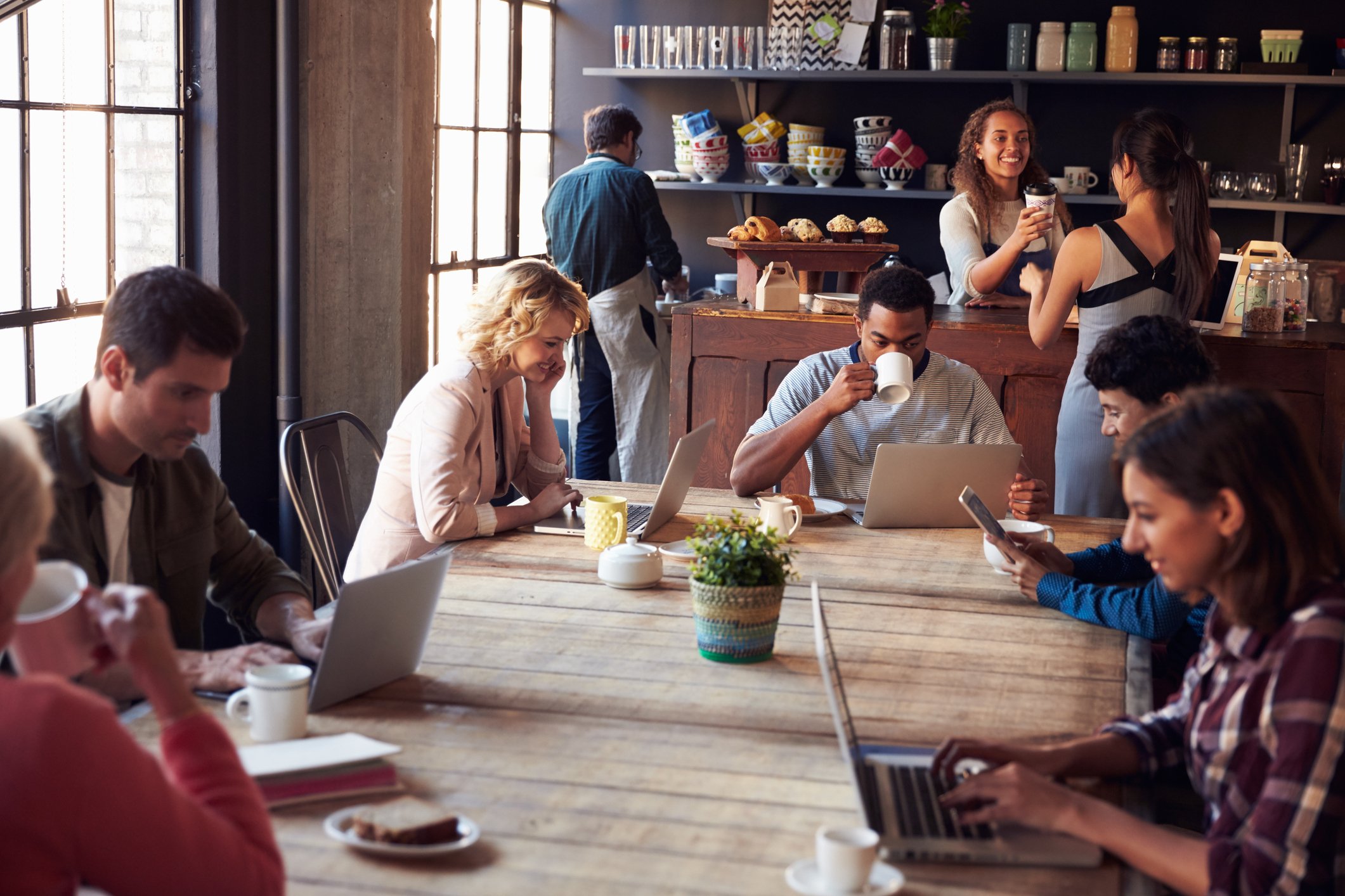 Customers at a table inside a coffee shop.