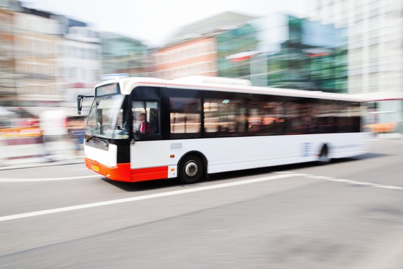 A city bus driving down the street.