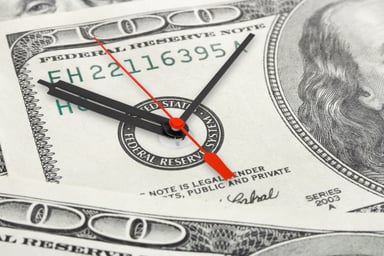 clock inside hundred dollar bill