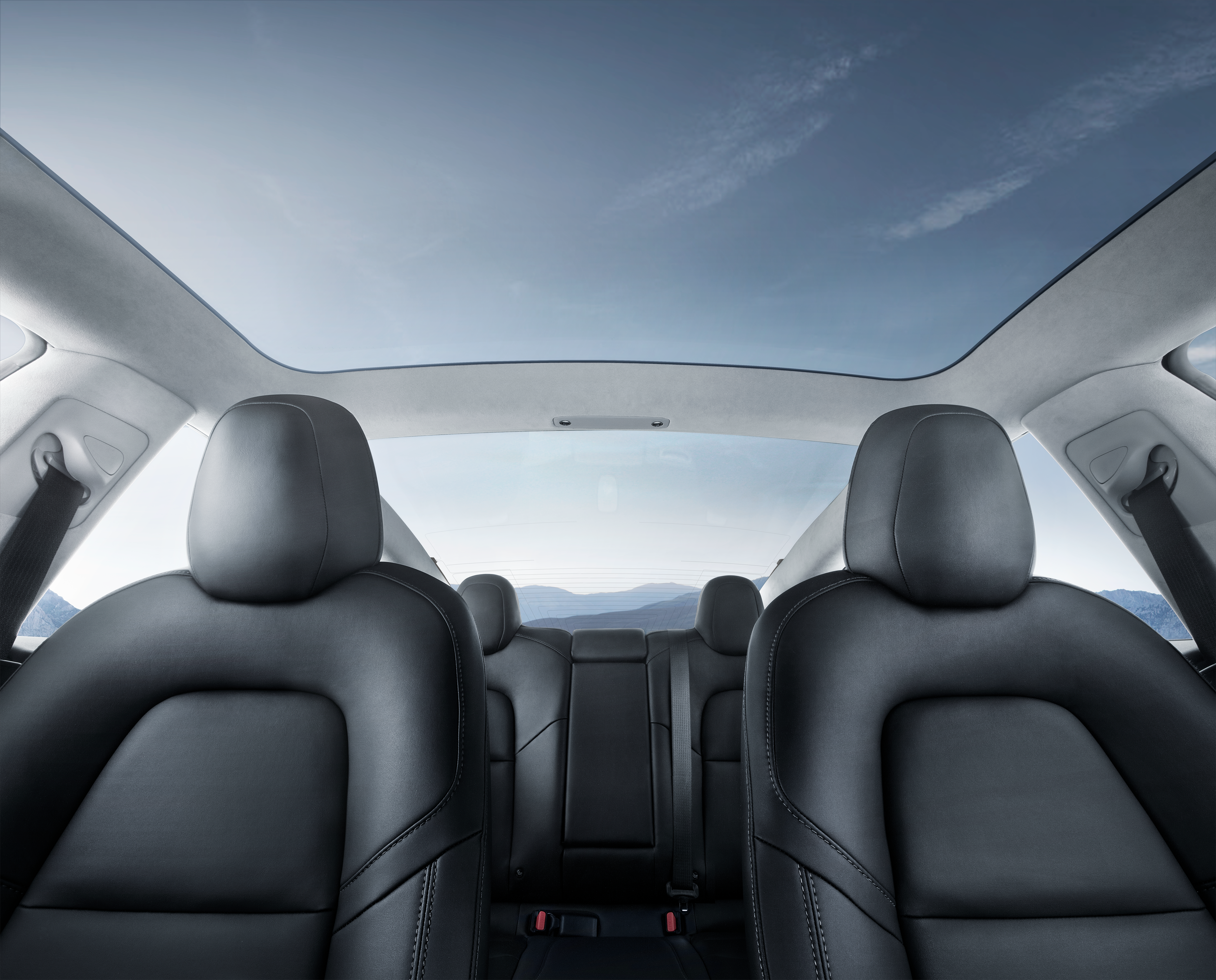 Model 3 interior, highlighting the vehicle's spaciousness and glass roof.