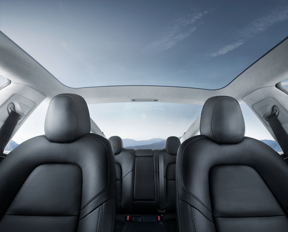 Model 3 interior, highlighting the vehicle's spaciousness and glass roof.