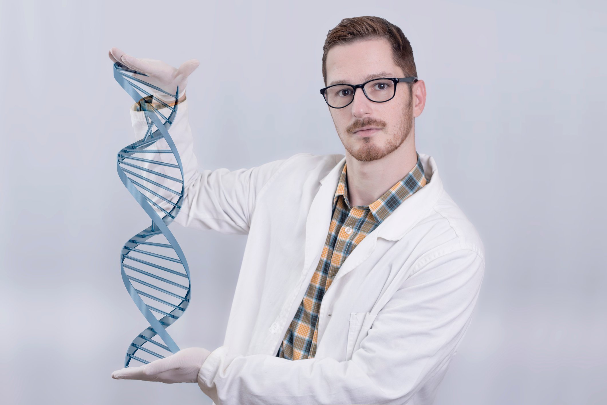 A biotech lab researcher holding a virtual DNA double helix.