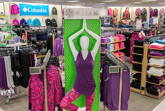 In a Kohl's store, a mannequin dressed in activewear stands in a yoga pose.