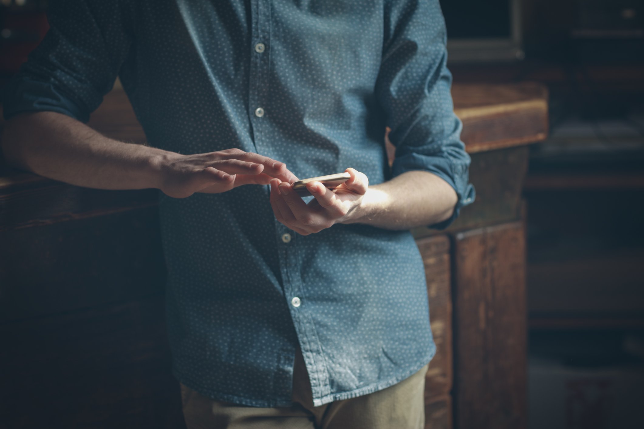 A man using a touchscreen smartphone.