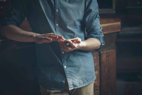 A man using a touchscreen smartphone.