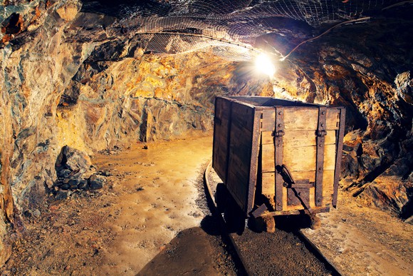 Wooden cart on rail track in gold mine