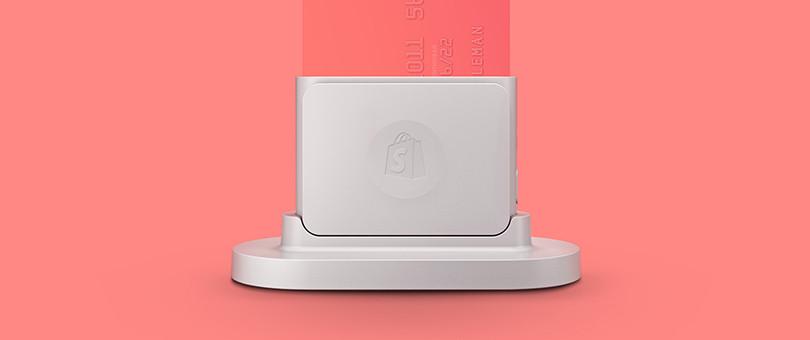 A small white credit card reader. 