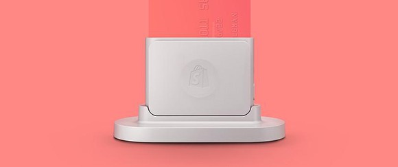 A small white credit card reader. 