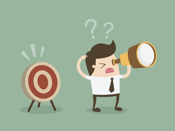 A confused cartoon businessman looking for an archery bulls eye that is right behind him. 