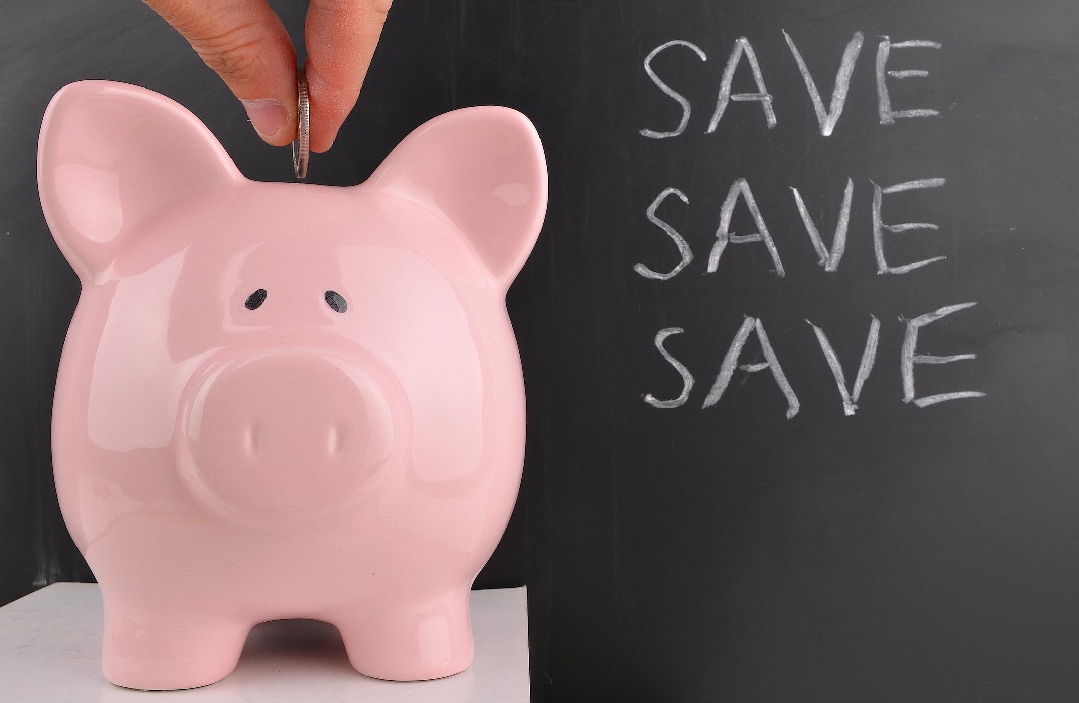 Piggy bank with the words "save save save" alongside it