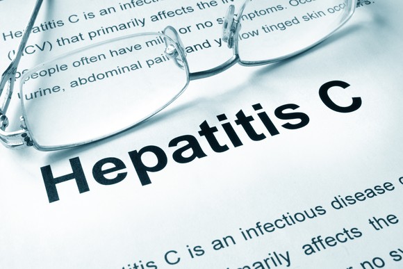 Paper with a description of hepatitis C typed on it with eye glasses laying on it