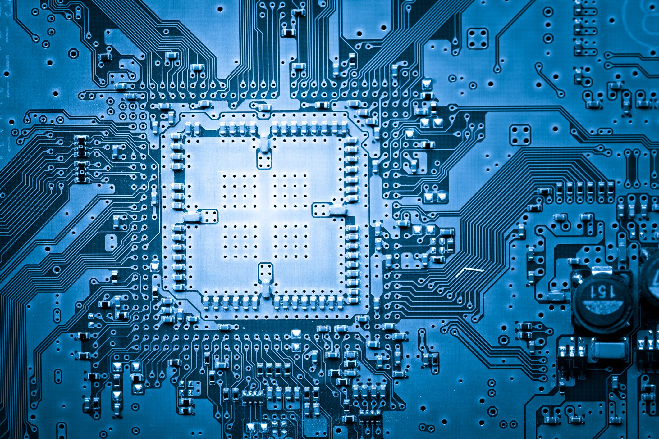 Blue-tinted circuit board with an empty processor socket.