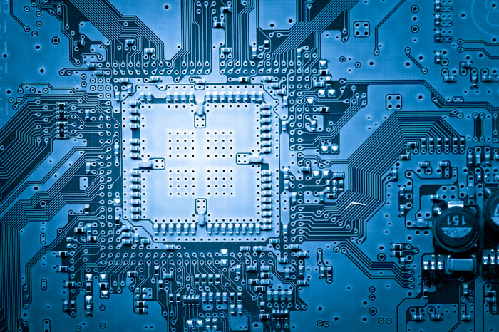 Blue-tinted circuit board with an empty processor socket.