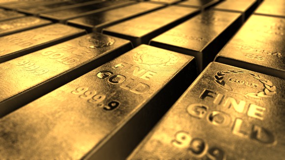Bars of gold stacked next to one another.