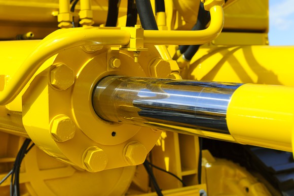 Large, yellow hydraulic piston in extended position.