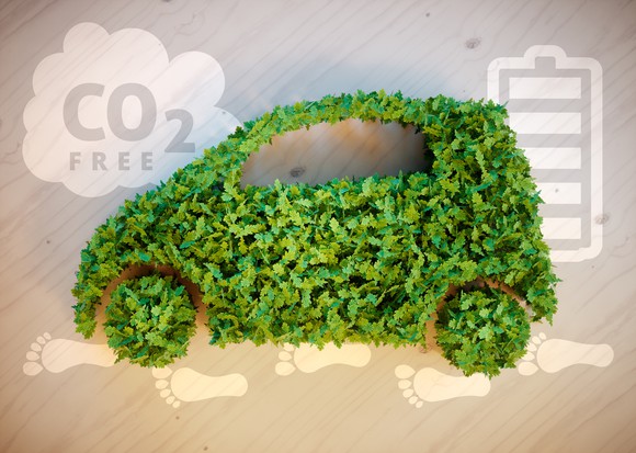 Illustration of a car made out of leaves with a CO2 free cloud in the background.