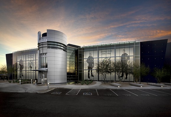 Axon Enterprise's headquarters with graphics of law enforcement on the windows. 