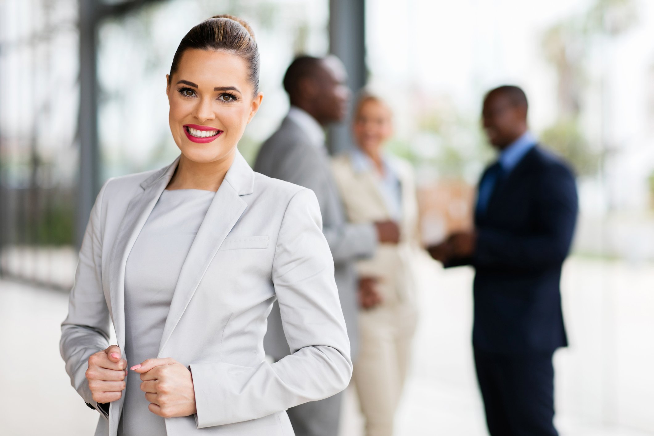 Smiling female in business suit wearing lipstick